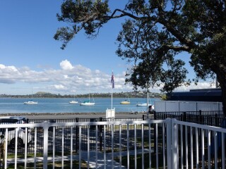 Image from The Beach House dementia care home overlooking Bucklands Beach and harbour with boats on the horizon.